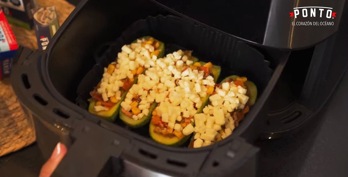 Gratina: Lleva las calabacitas a la freidora de aire y cocina hasta que el queso esté completamente derretido y ligeramente dorado.<br> Sirve calientes y termina con un poco de cilantro fresco.<br> El resultado son unas calabacitas suaves y jugosas, con un relleno lleno de sabor y una capa de queso mozzarella doradita que hace que cada bocado sea todavía más irresistible.<br> Además de ser una forma diferente de disfrutar sardinas, este platillo combina proteína, verduras y el sabor de ingredientes que seguramente ya tienes en casa.